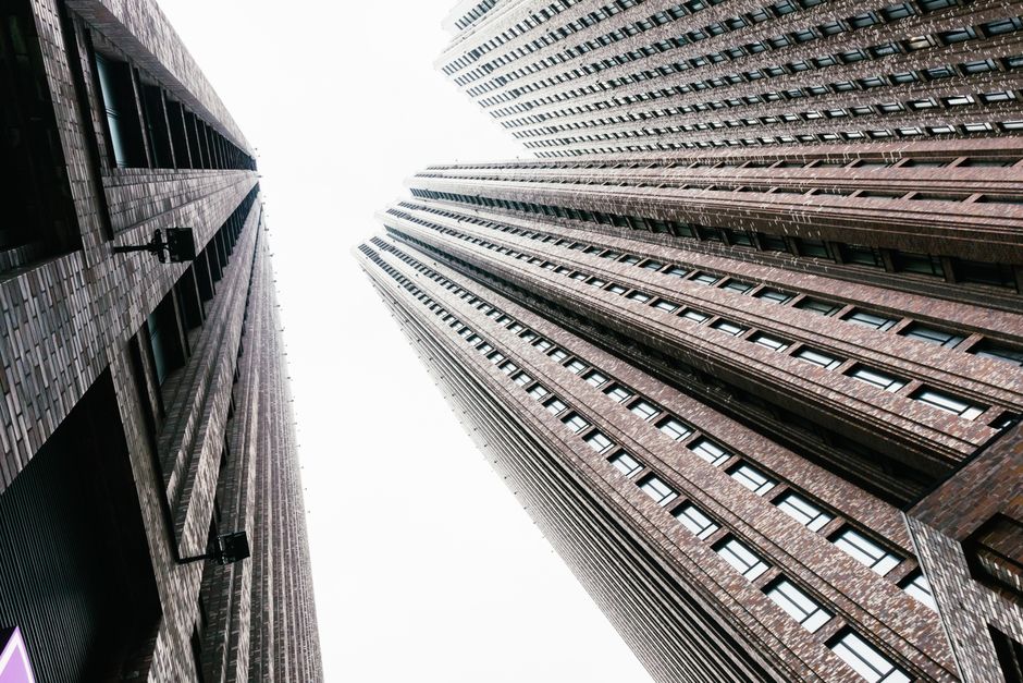 Low-angle shot of modern skyscrapers with a dramatic view against a clear sky.