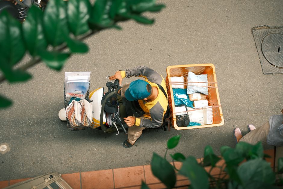 Top view of a delivery worker on a scooter in a street in Hong Kong.
